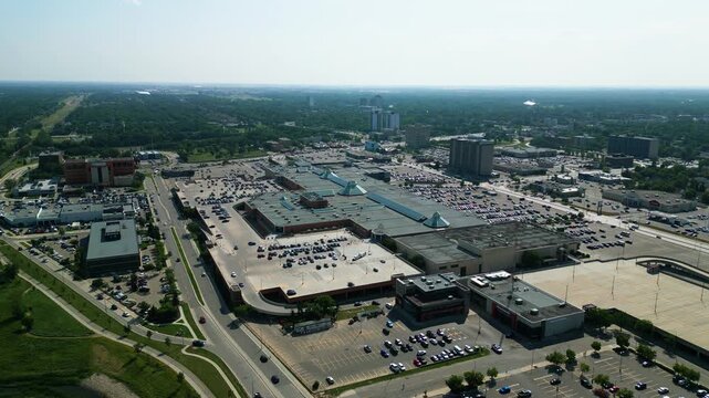 Static aerial timelapse of traffic, vehicles, and commercial activity around CF Polo Park shopping centre in Winnipeg on a bright summer day
