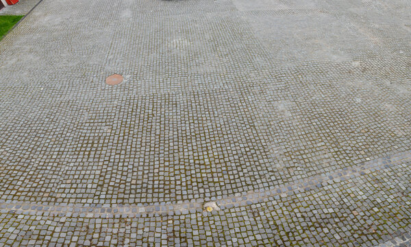 Aerial view of an extensive cobblestone pavement in an urban setting.