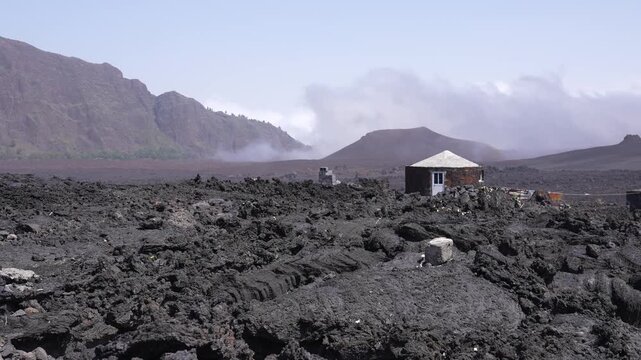 Timelapse of Volcanic Smoke Moving Above Lava Fields and Traditional Funco House on Fogo Island, Cape Verde
