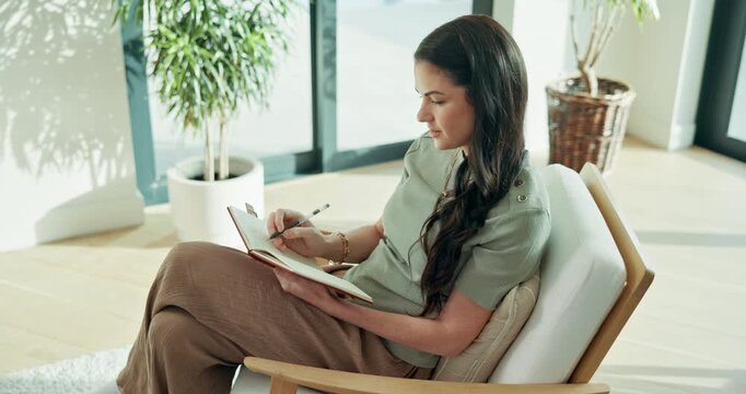 Woman, writing and ideas with notebook in home, creative and planning for goals with smile and info. Journaling, notes and happy person with journal, reminder and schedule agenda with diary in house