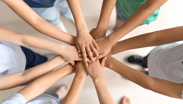 Overhead View of Diverse Children's Hands Stacked Together, Symbolizing Teamwork, Unity, and Friendship