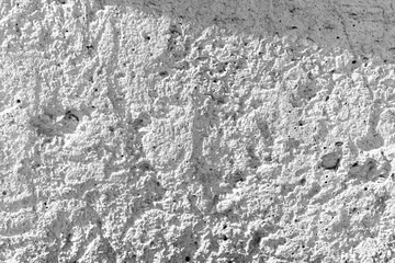 Naklejka premium Rough concrete background with shadow casting on its textured exterior