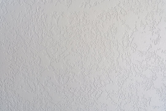 Textured white wall background with rough plaster finish