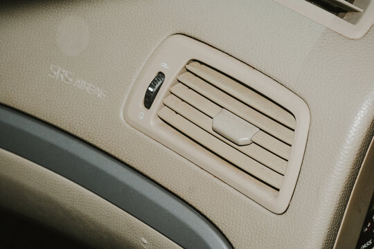 Car interior dashboard air vent and SRS airbag warning label
