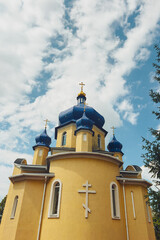 Orthodox church with blue domes against a cloudy sky © reddish