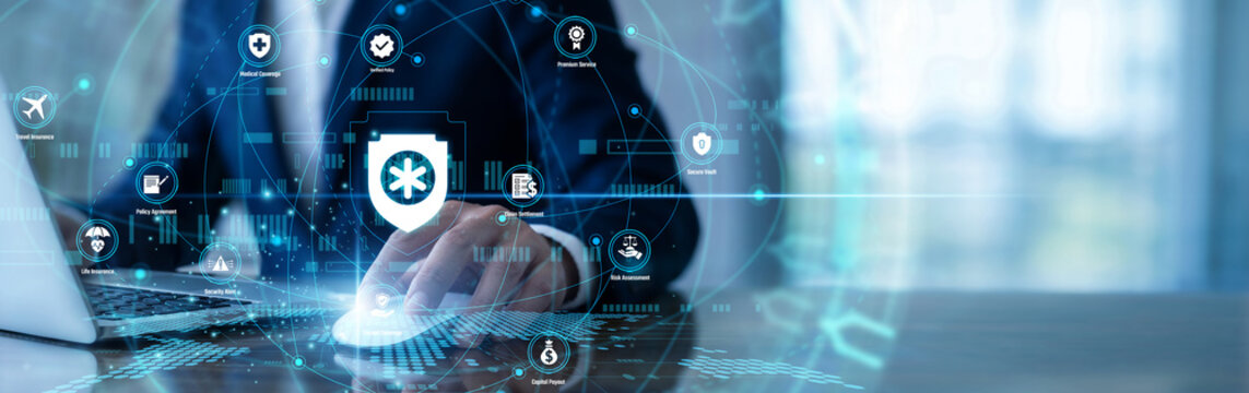 Analyst working on laptop using InsurTech network platforms to process insurance claims quickly. Assessing risks and calculating premiums to provide modern, efficient coverage for customers.
