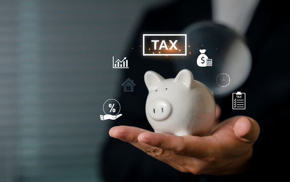 A Business man holds a piggy bank with floating digital icons representing tax, finance, and economy, symbolizing savings, financial planning, and monetary management.