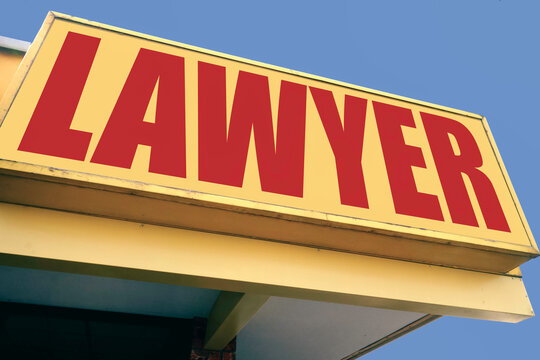 Aged and worn lawyer sign on building