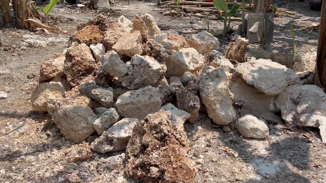 Pile of natural limestone rocks and boulders on dry ground