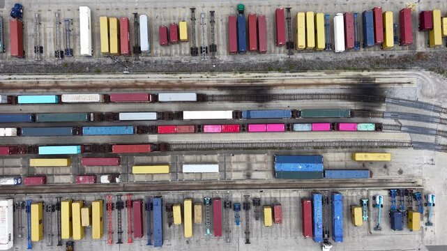 Aerial top down view of a freight train yard with colorful containers