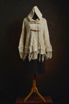 Beige Knitted Hooded Cape or Poncho on a Mannequin Display