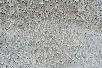 Fototapeta premium Coarse grey textured plaster wall background full frame close up for construction and interior design concept. High quliaty