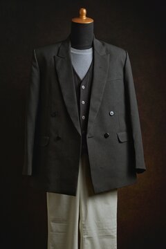 Classic double-breasted blazer and vest with white trousers on a mannequin display