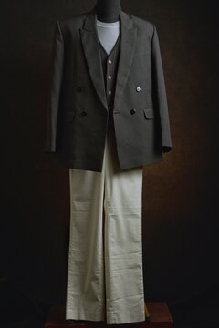 Classic double-breasted blazer and vest with white trousers on a mannequin display