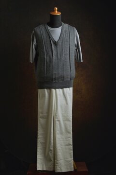 Men's casual style, T-shirt with grey vest mix with white trousers displayed on a dress form