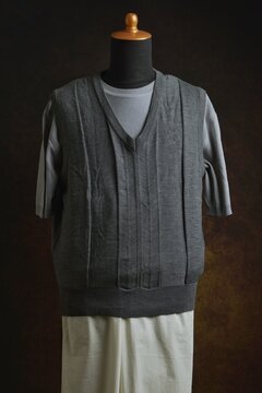 Men's casual style, T-shirt with grey vest mix with white trousers displayed on a dress form