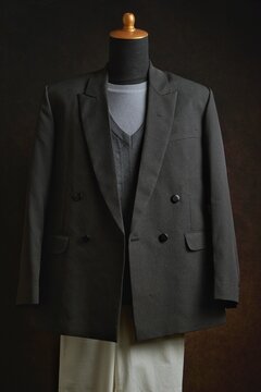 Classic double-breasted blazer and vest with white trousers on a mannequin display