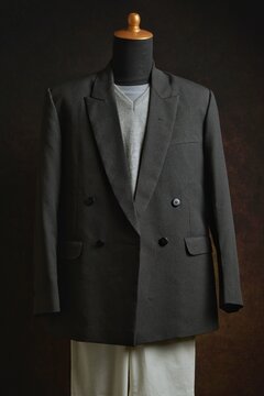 Classic double-breasted blazer and vest with white trousers on a mannequin display