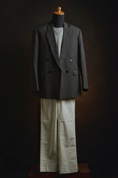 Classic double-breasted blazer and vest with white trousers on a mannequin display
