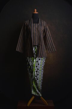 Traditional Indonesian Kebaya with Lurik Pattern or vertical pattern with batik skirt on a display mannequin
