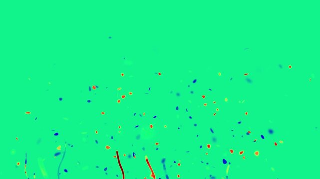 Colorful confetti and paper streamers burst upwards against a bright green screen background for festive celebrations.