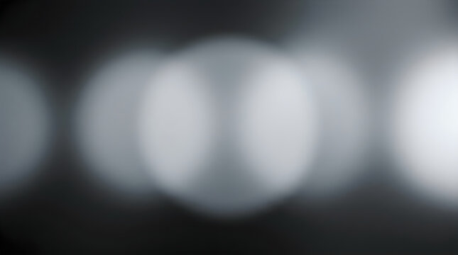 Abstract background featuring soft white circular bokeh lights glowing against a dark moody grey backdrop perfect for modern design and artistic digital