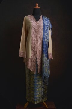 Indonesian Kebaya with Embroidered Lace Accent and Batik Skirt and Shawl Displayed on A Dress Form