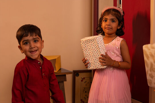 Children enjoying a festive moment with a gift