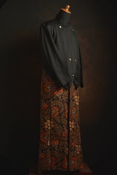 Traditional Javanese Suit with Beskap and Batik Sarong on a Mannequin Display 