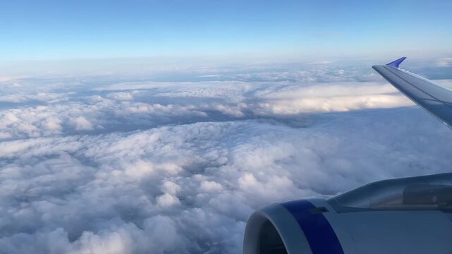 Stunning aerial view of clouds from airplane window during flight.