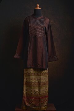 Traditional Baju Kurung with Songket Skirt on a Mannequin Display
