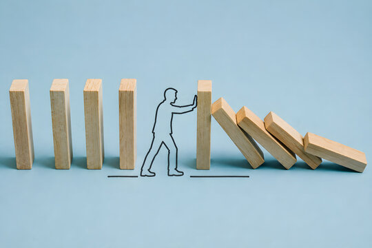 Wooden blocks show a person stopping a chain reaction, symbolizing risk prevention, timely intervention, resilience, and problem solving.