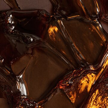 Thick purple-black syrup with a glossy sheen flowing over a dark surface, showing viscous textures and amber highlights for design backgrounds