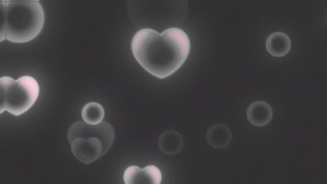 Heart shapes with glowing outlines float peacefully alongside soft bokeh particles against a dark backdrop.