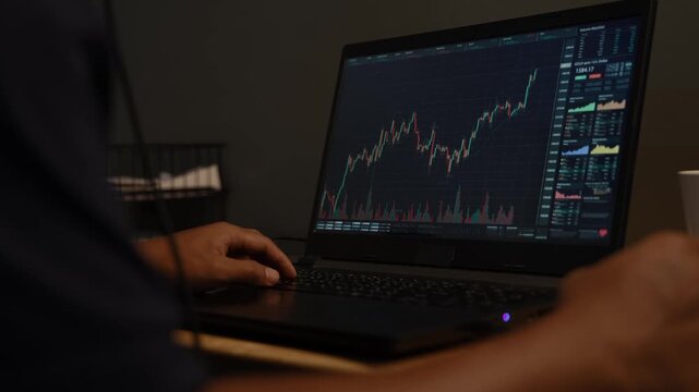 Stock crypto trader looking at computer analyzing trading crypto currency finance market crypto stock market data.