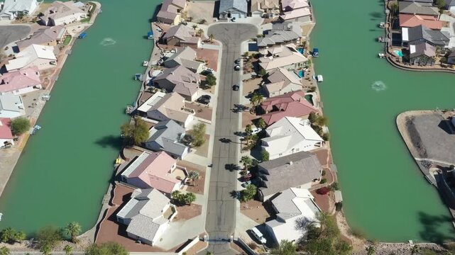 Aerial view of waterfront homes on a green canal