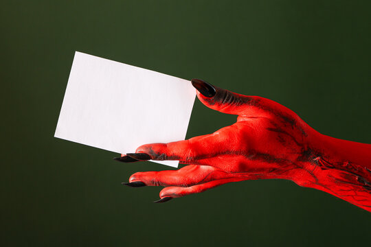 Halloween. Creepy red hand with long nails presents blank card for Halloween events