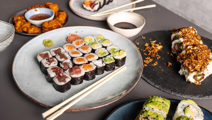 Assortment of fresh sushi maki rolls on plates with soy sauce © Cavan