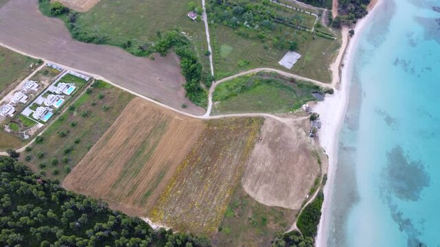 Turquoise Scenic Kassandra Coastline with Beach, Farmland, Forest and Luxury Villa in Greece Aerial View