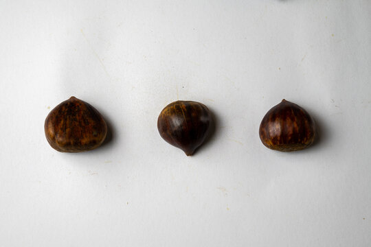 Three chestnuts on white background