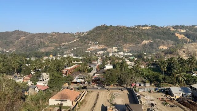 Kuta Lombok, Indonesia, showing rapid tourism development with new buildings, construction, roads and infrastructure expanding across the tropical valley landscape.