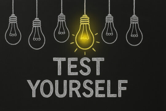 Test yourself motivational concept with hanging sketch lightbulbs on black chalkboard, one glowing yellow symbolizing bright idea and self challenge for education and inspiration