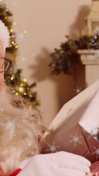 Snowflakes falling against Santa Claus holding gift with finger on lips