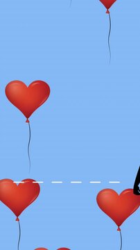 Multiple heart shaped balloons floating against silhouette of two woman wearing face masks