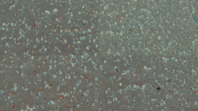 Colorful terrazzo floor surface with small stone chips in a close-up static view