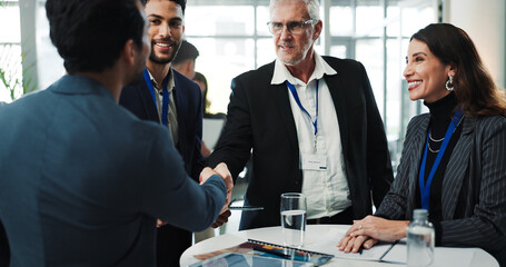 Business people, conference and shaking hands for introduction, meeting and greeting with smile. Seminar, happy group or handshake for welcome, hello or networking event for partnership collaboration © peopleimages.com