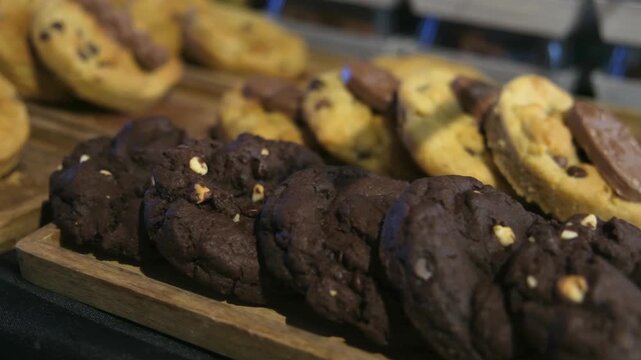 Rows of chocolate chip and peanut butter swirl cookies arranged in a bakery display case