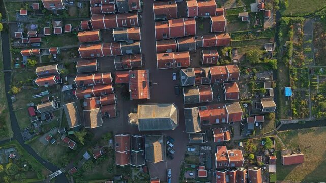 Spectacular top down aerial view of the historic village of marken in the netherlands, showing its characteristic houses and canals at sunset