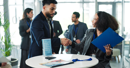 Business people, conference and shaking hands for meeting, greeting guest and empowerment event. Transformation seminar, happy group or handshake for welcome, hello or networking with clipboard © peopleimages.com