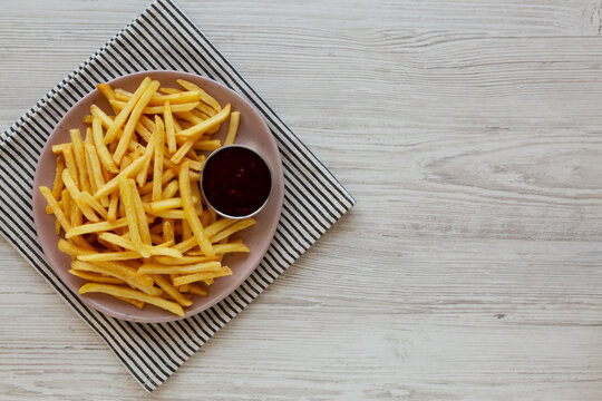 Homemade French Fries with Sweet and Sour Sauce, top view. Copy space.